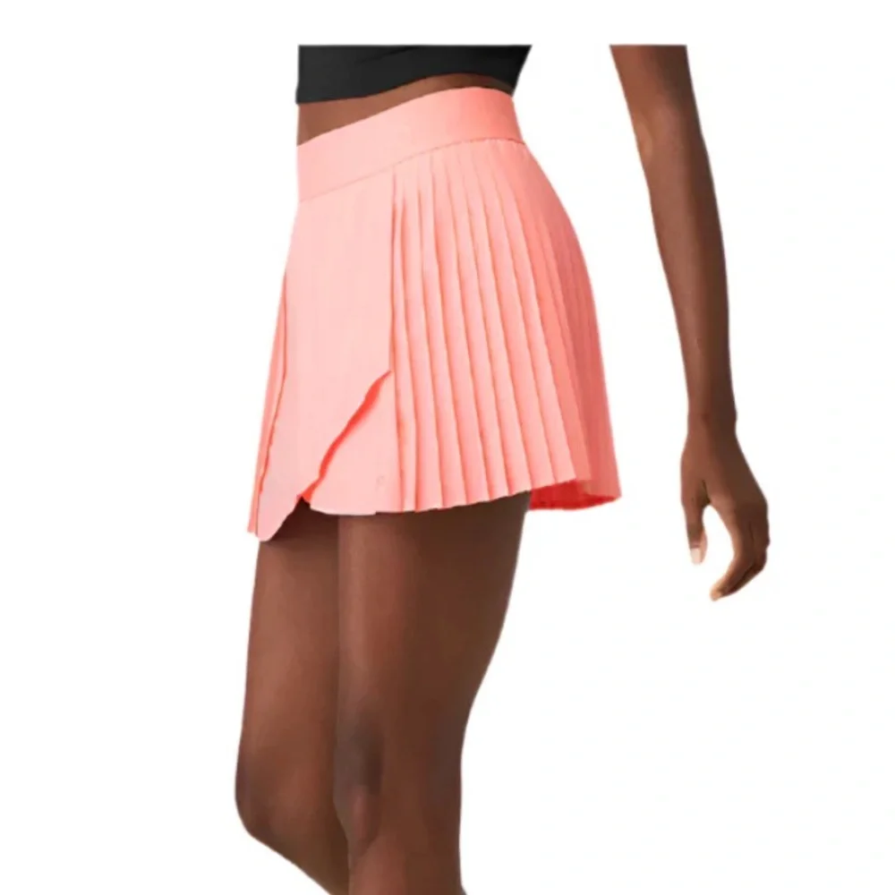 ALO Yoga Pleated Mini Skort in Coral Pink